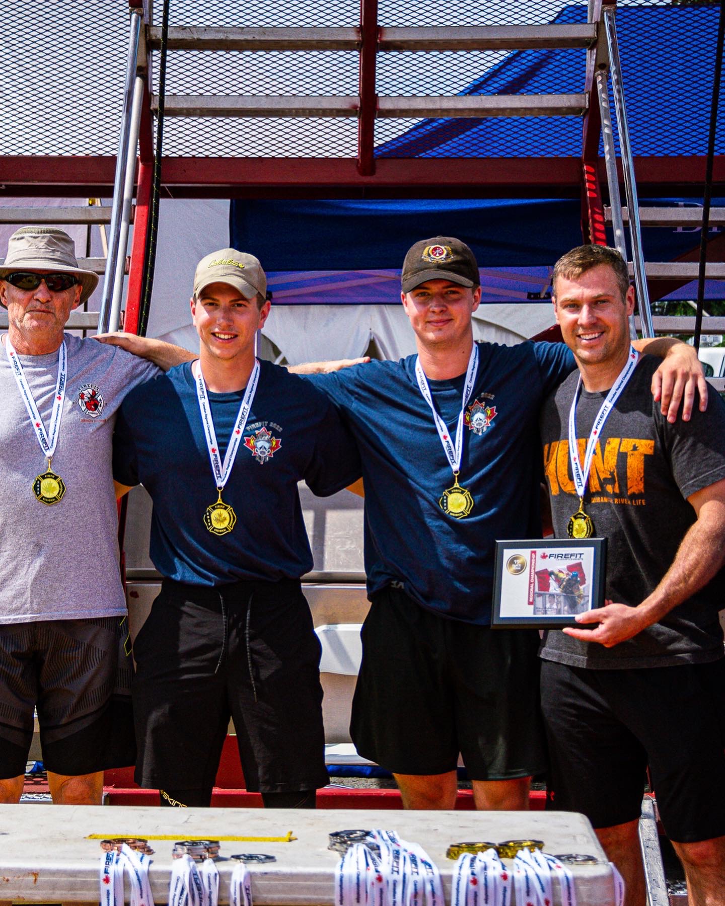 Team gold medal winners at FireFit Championships podium