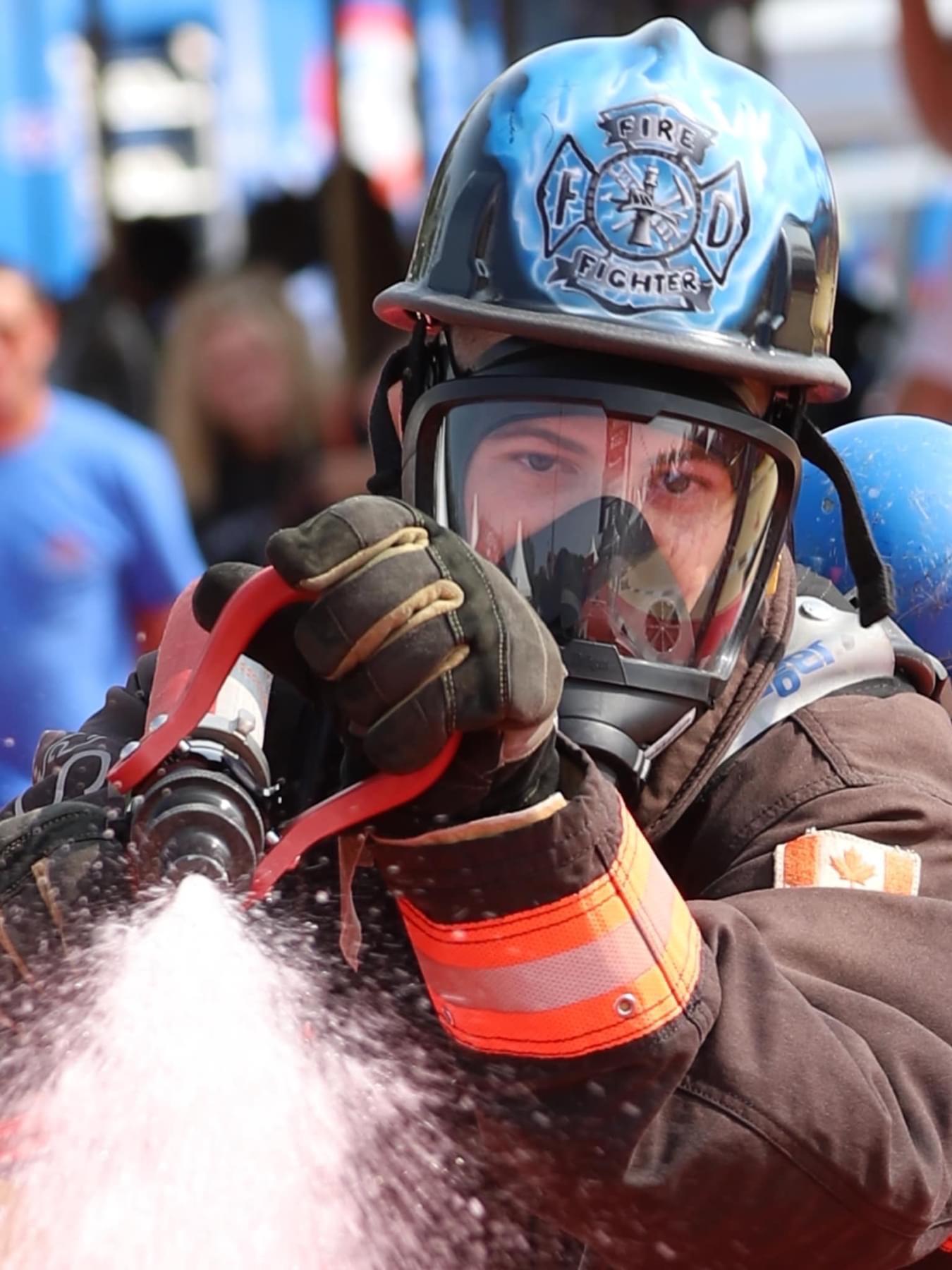 Close-up of firefighter operating hose nozzle with precision and focus
