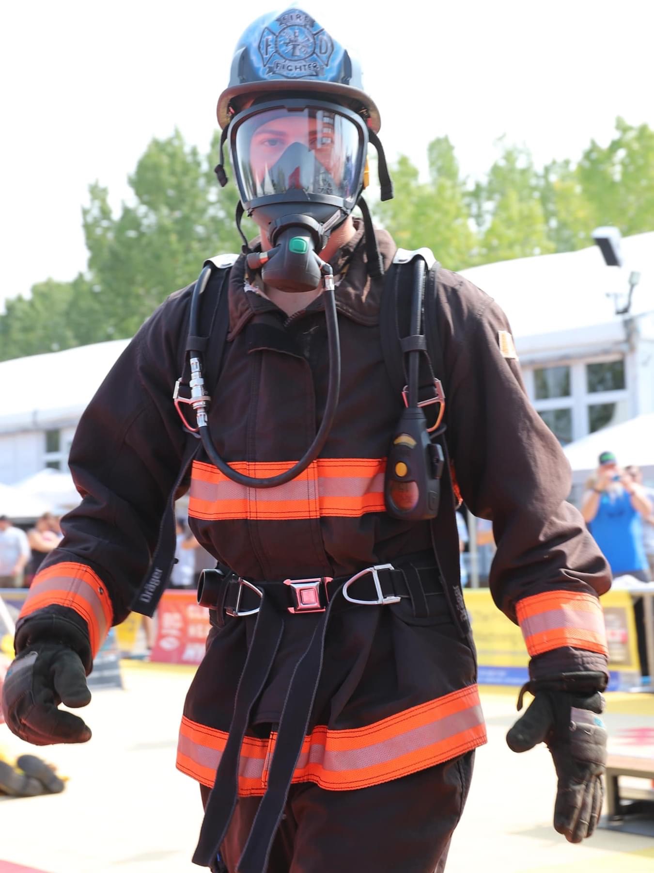 Firefighter in full gear walking with determination at FireFit Championships
